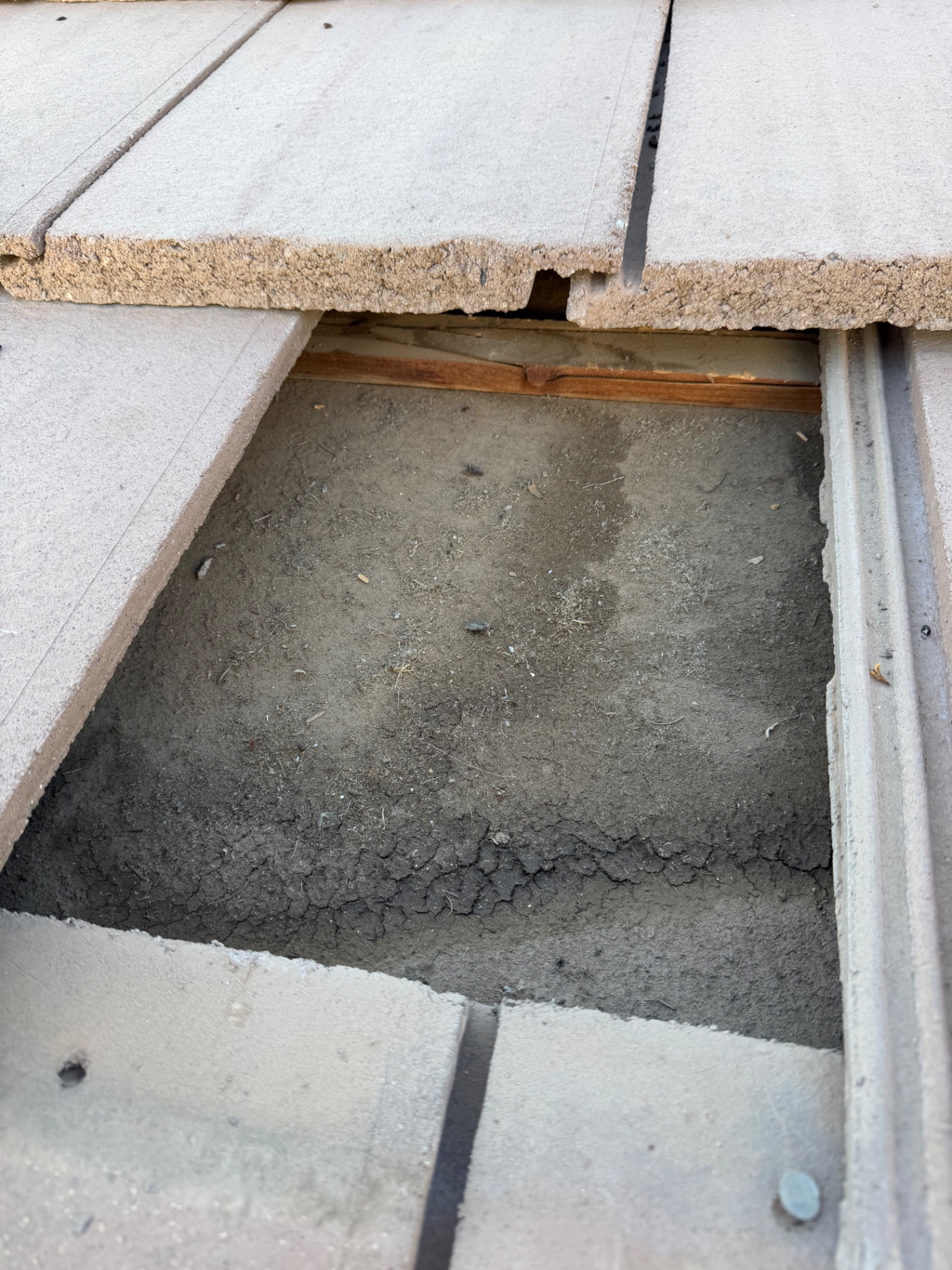 Missing tile exposing roof deck