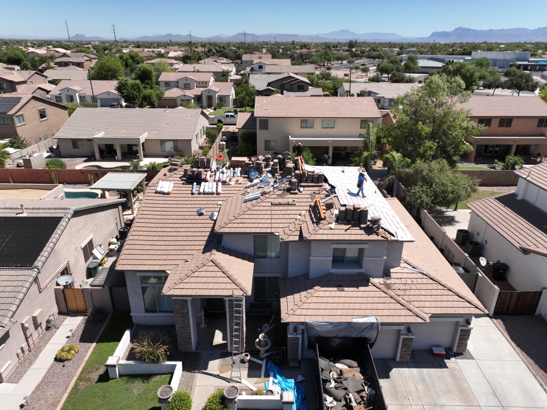 Aerial view of tile roof tear-off in progress