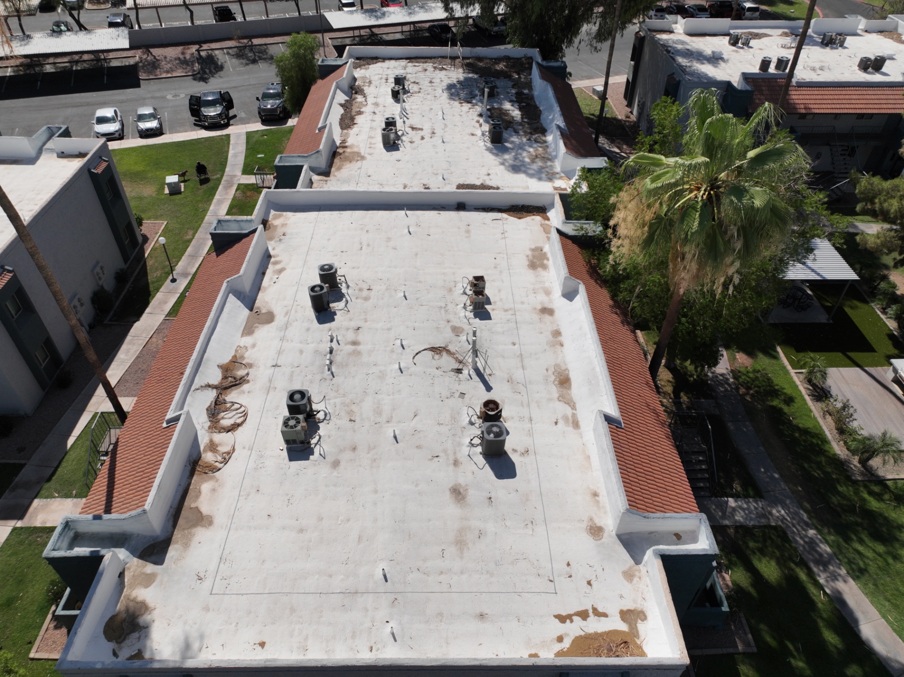 Weathered spray foam roof with worn elastomeric coating on Chandler AZ apartment building