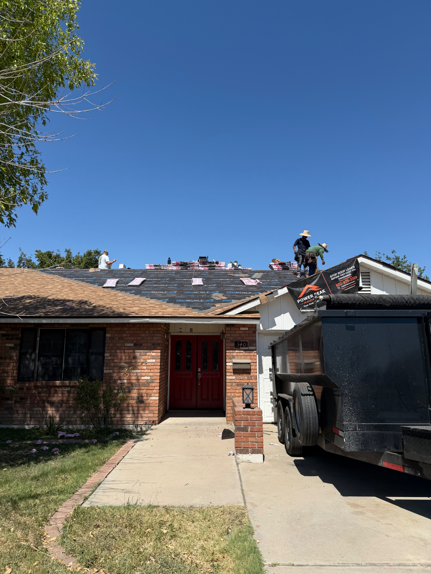 Street view of Mesa roof replacement with crew and Power Peak banner