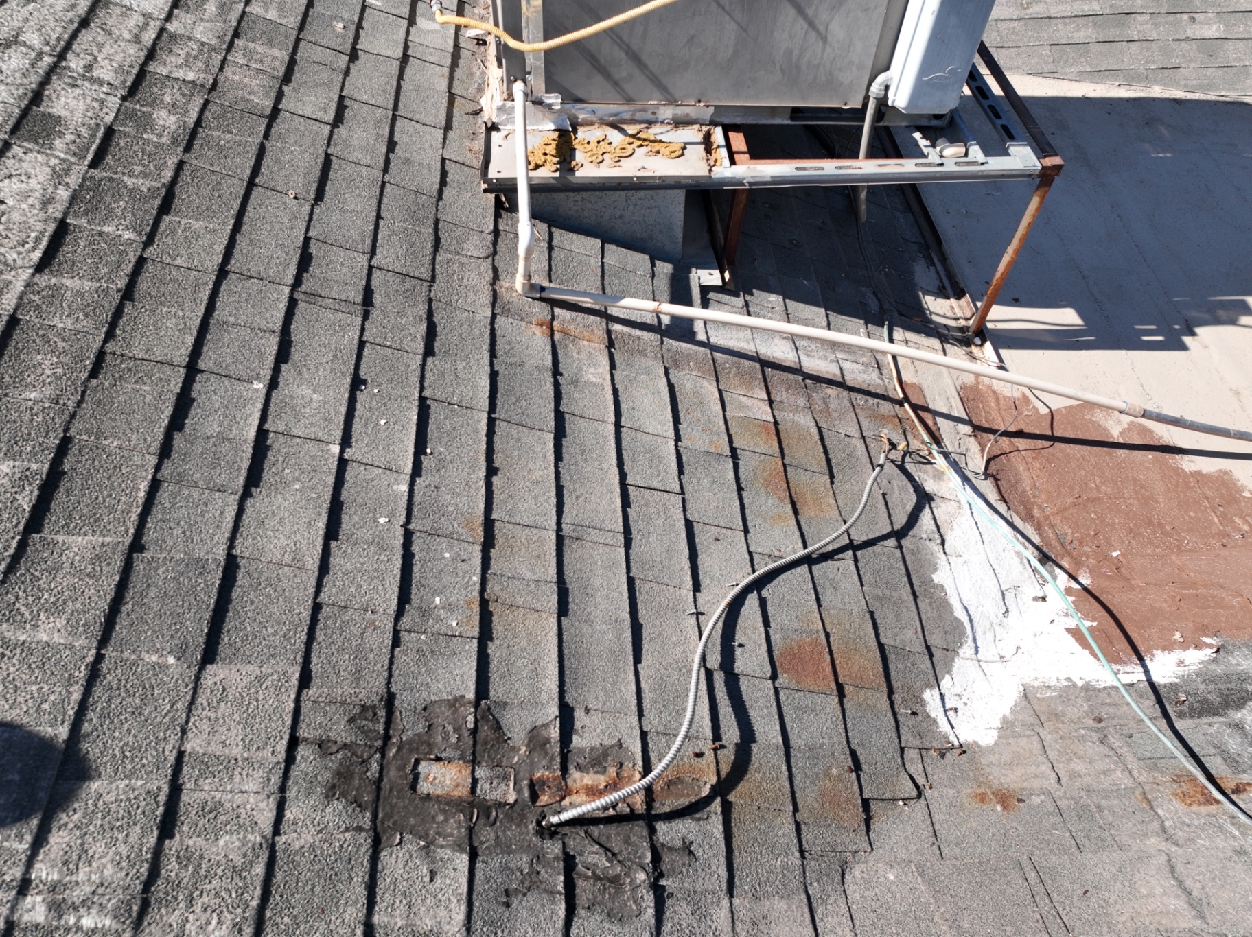 Failed HVAC curb flashing with cracked sealant and exposed penetrations on Mesa AZ roof