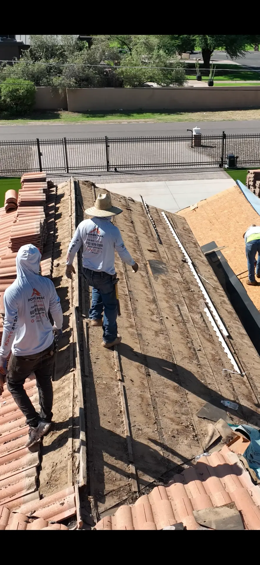 Power Peak Roofing crew tearing off tile and old underlayment on a Chandler AZ roof