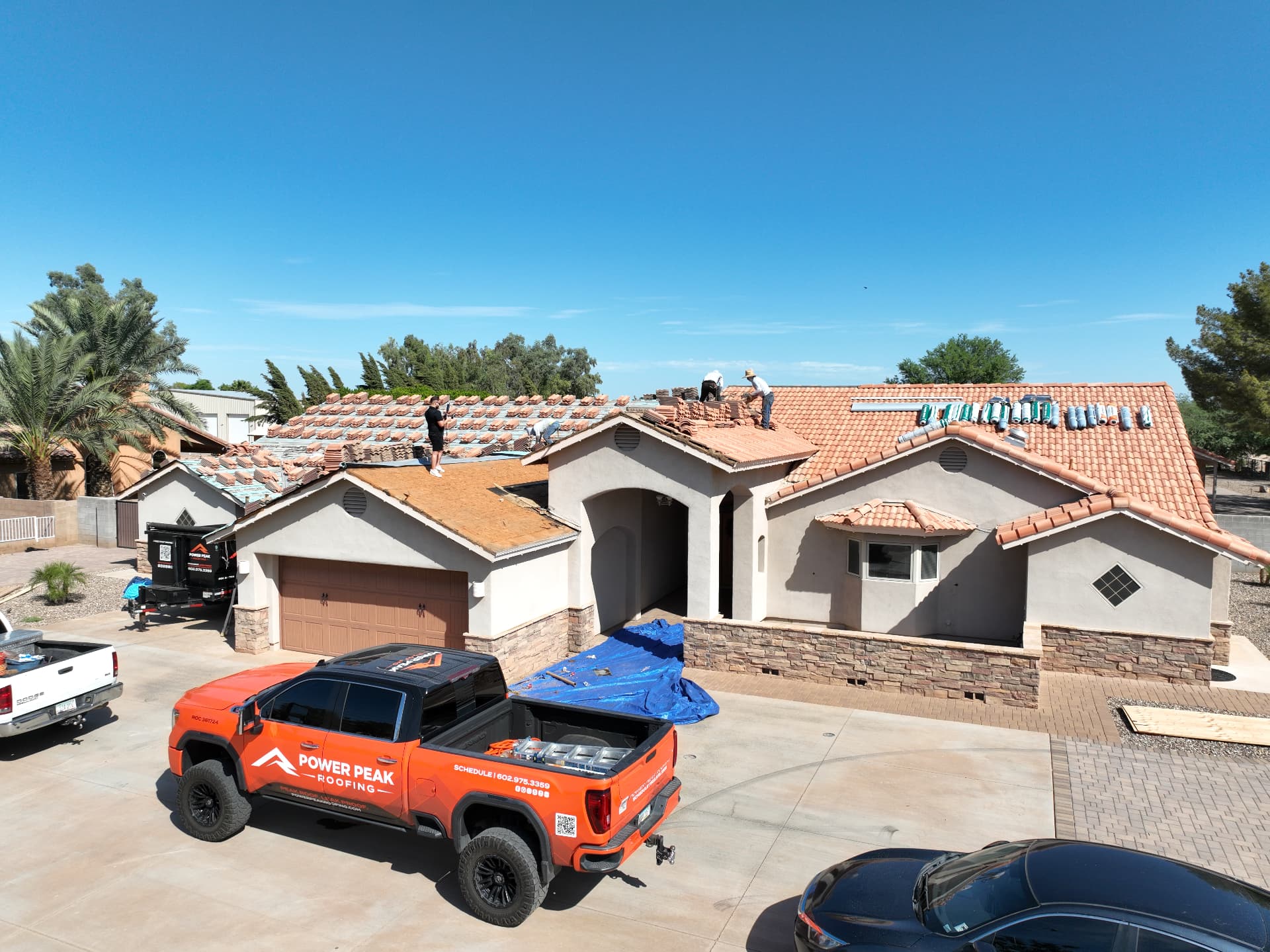 Aerial view of the Power Peak Roofing crew loading concrete tile on a Chandler AZ 85249 home