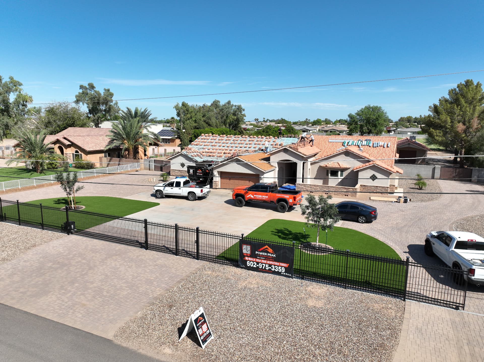 Wide aerial view of a Chandler AZ 85249 county island tile re-roof in progress with the detached garage