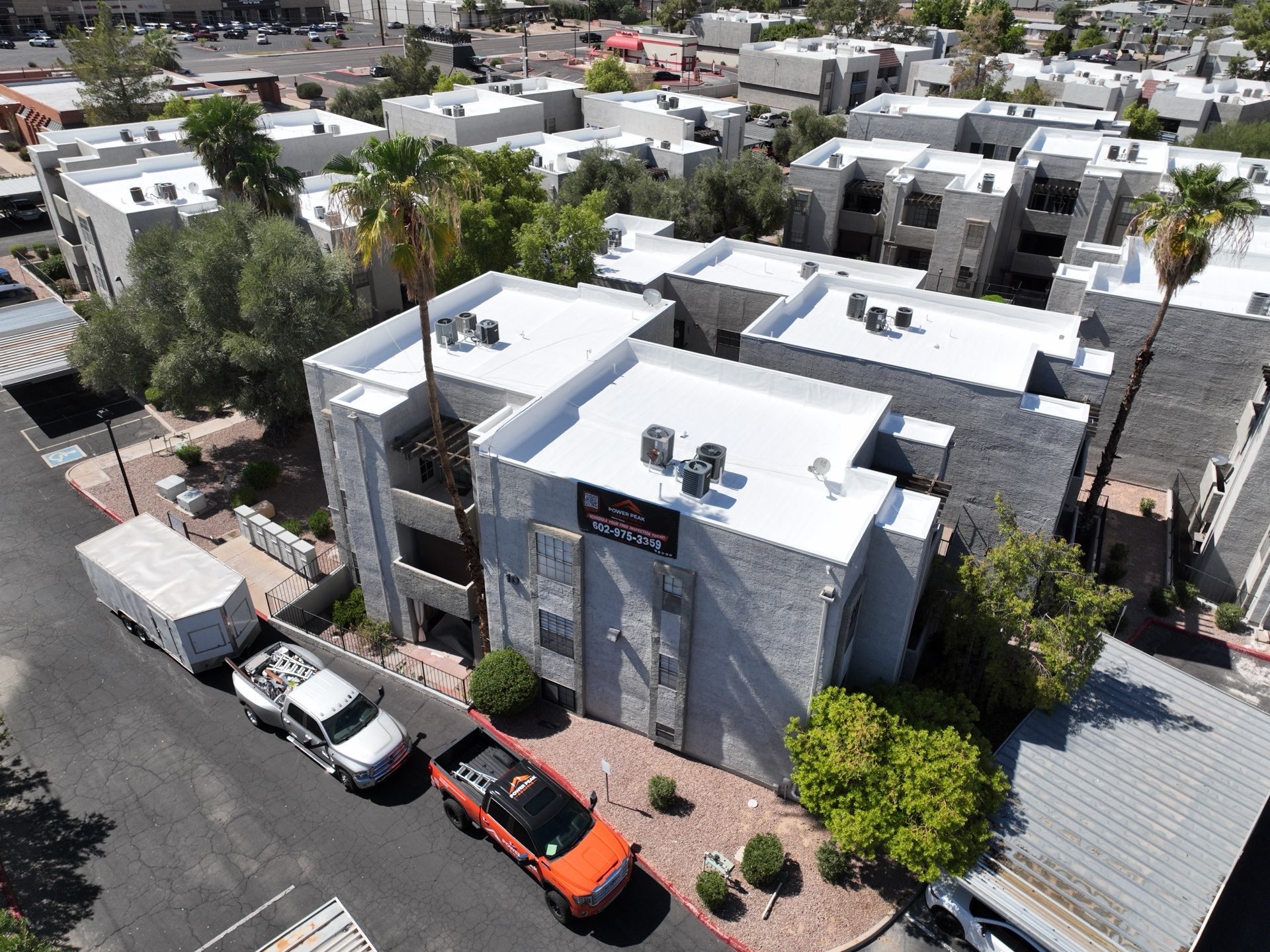 Aerial view of completed elastomeric roof recoating on condominium buildings in Scottsdale AZ 85251