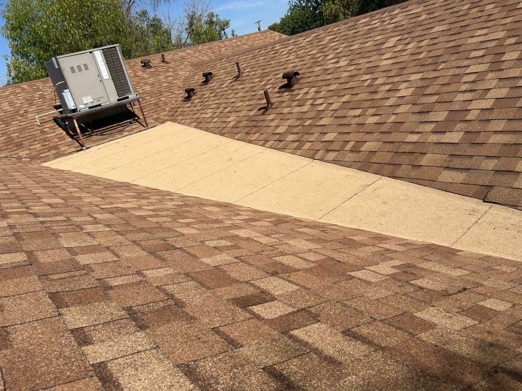 Completed transition between new architectural shingles and low-slope coated section