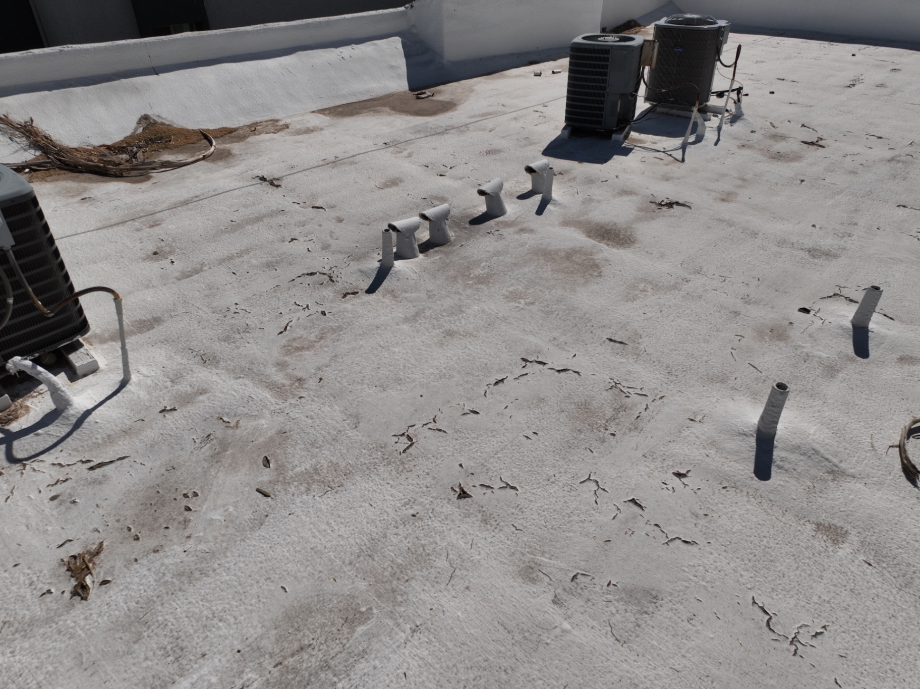 Chalking spray foam roof with vent stacks on Chandler AZ apartment