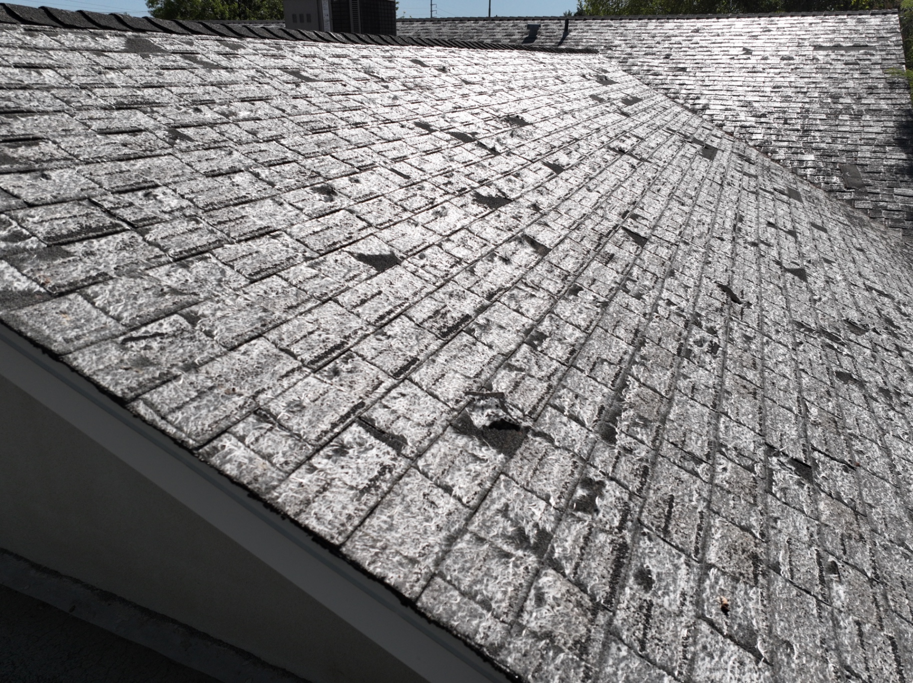 Degraded asphalt shingles at eave line of Mesa AZ home