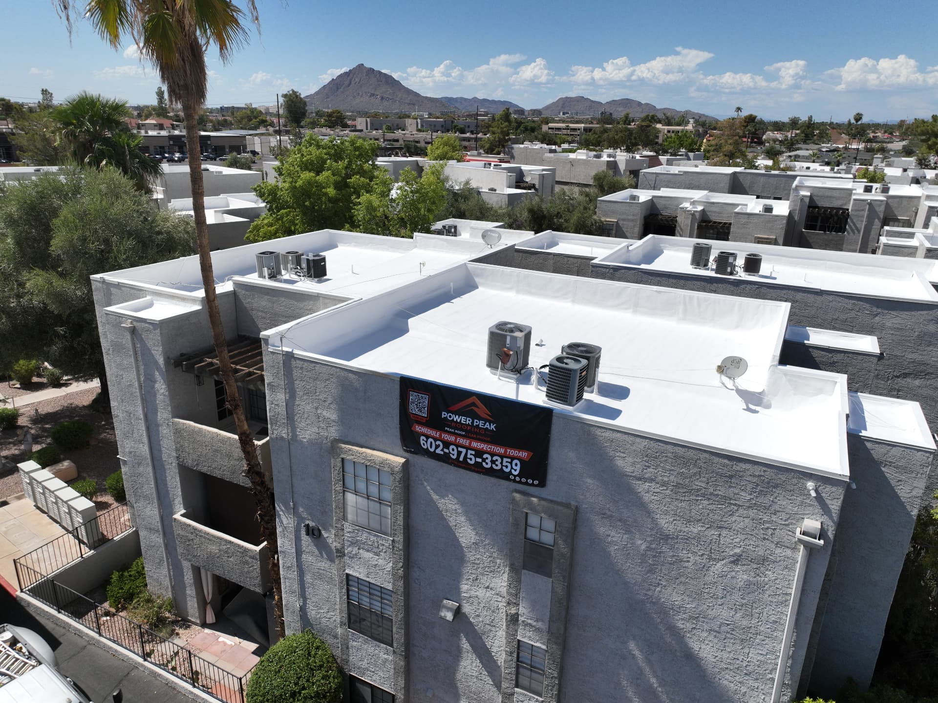 Completed white elastomeric roof coating on a Scottsdale AZ condominium building by Power Peak Roofing